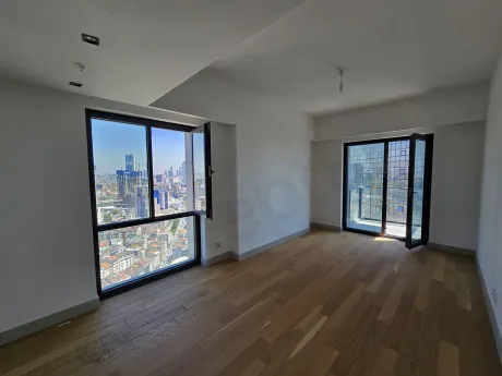 Spacious and bright living room area of a modern residence with large windows.