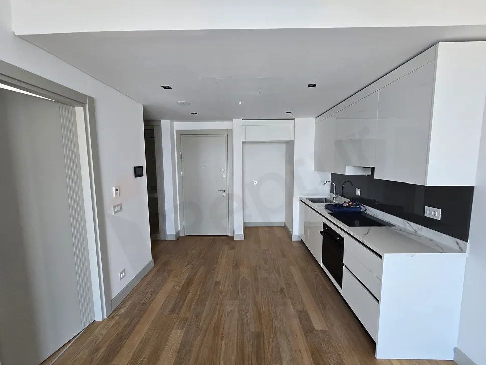 Spacious kitchen area with a modern and minimalist design.