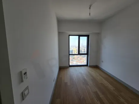 View of a bright and modern bedroom with large windows.