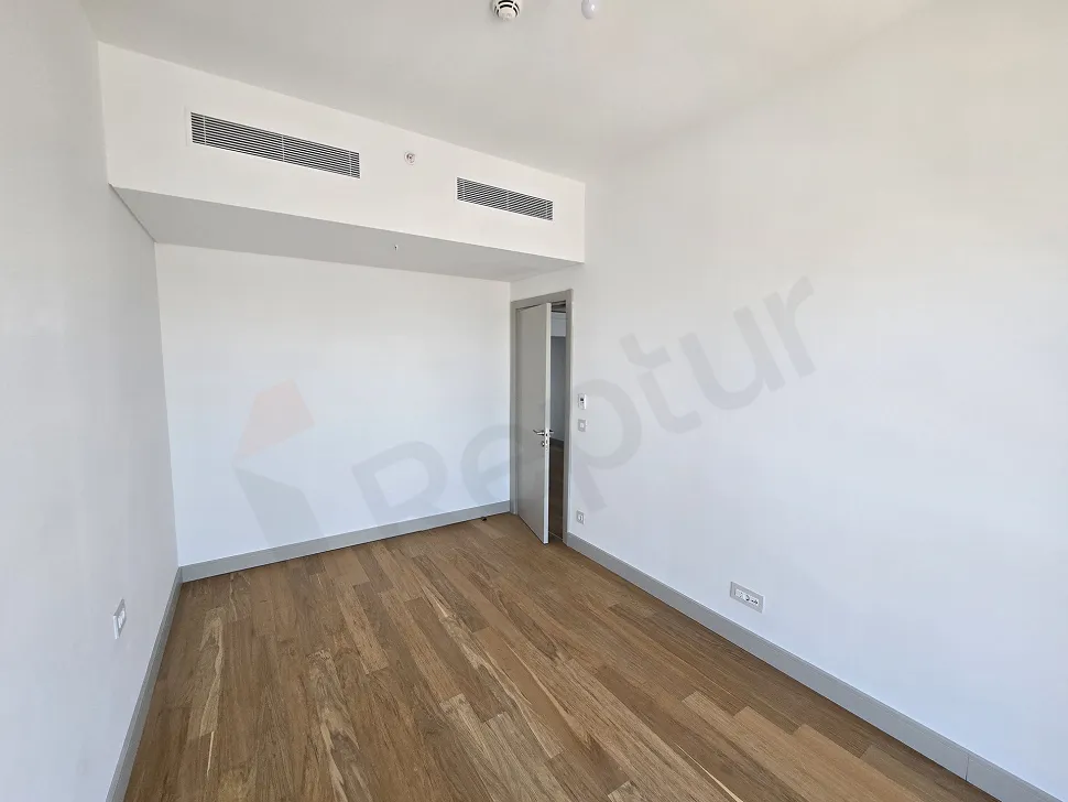 Spacious and bright bedroom area with large windows in a modern residence apartment in Sisli, Istanbul.