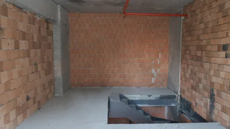 Unfinished shop interior with concrete floors and wide windows in Başakşehir, Istanbul.