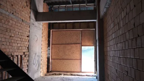 Spacious shell and core shop interior with concrete floors and unfinished walls