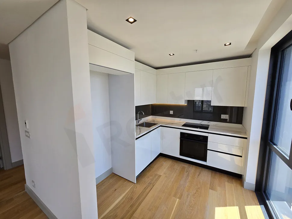 Modern designed, spacious and bright kitchen area of a residence apartment.