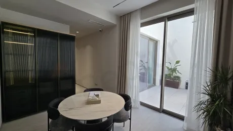 Modern, spacious, and bright dining room area of a luxury detached house.