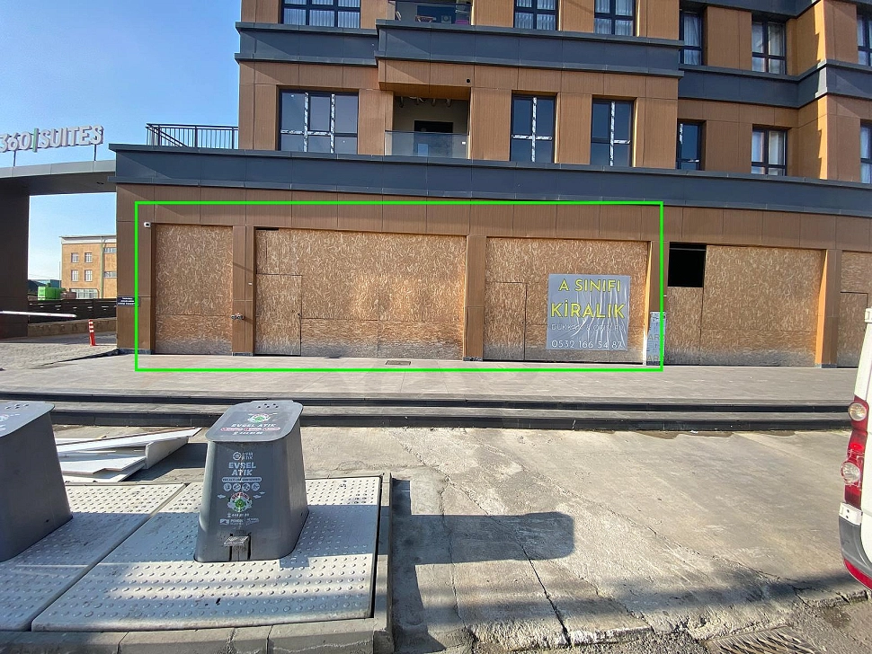 Exterior facade view of a modern shop with large glass display windows in Pendik.