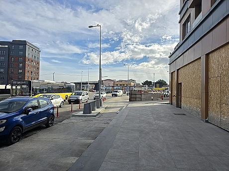 Secure access control gate at the entrance of a modern commercial building.