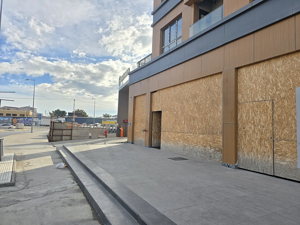 Exterior view of a modern commercial shop featuring large glass windows and a storefront.