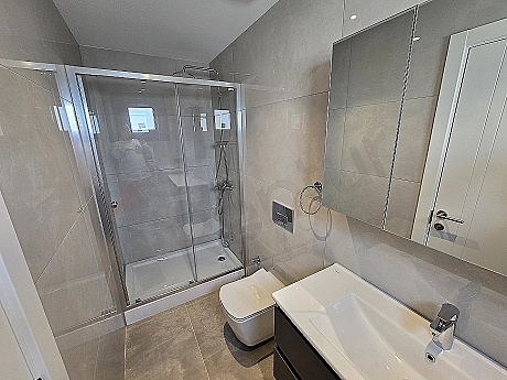 Modern designed, stylish bathroom with white ceramics, mirrored and illuminated.