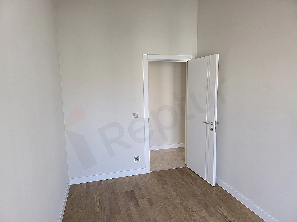 Modern designed bedroom interior, wooden parquet flooring, stylish headboard and natural light window detail.