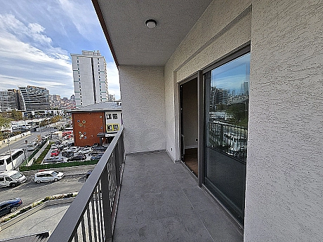 Image of a modern apartment with a spacious balcony.