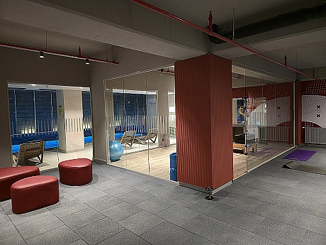 Modern gym with equipment and spacious exercise area.