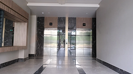 Interior of a modern elevator cabin with stainless steel details and lighting