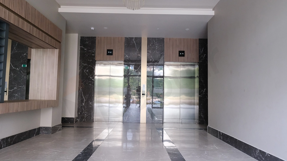 Interior of a modern elevator cabin with stainless steel details and lighting