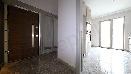 Apartment entrance door and hallway detail.