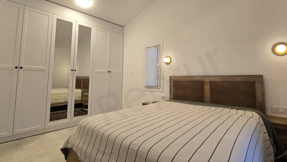 Modern and comfortably furnished bedroom image of a 3+1 villa for sale in Milas, Muğla.