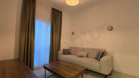 A spacious and bright villa living room furnished with modern furniture.