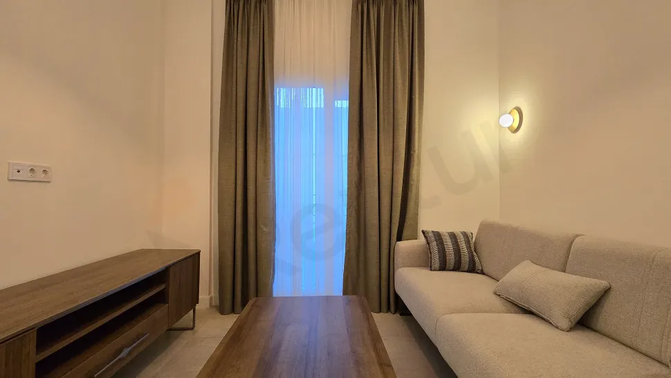 Spacious living room with modern and stylish furniture in a 3+1 villa for sale in Milas, Mugla.