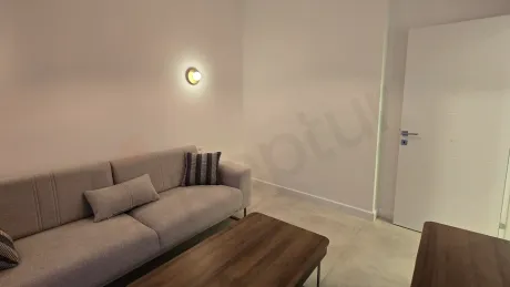 A spacious and bright villa living room furnished with modern furniture.