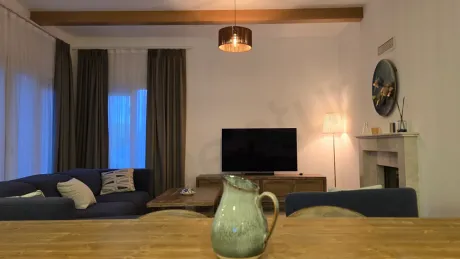 A spacious and bright furnished living room of a villa with modern furniture.