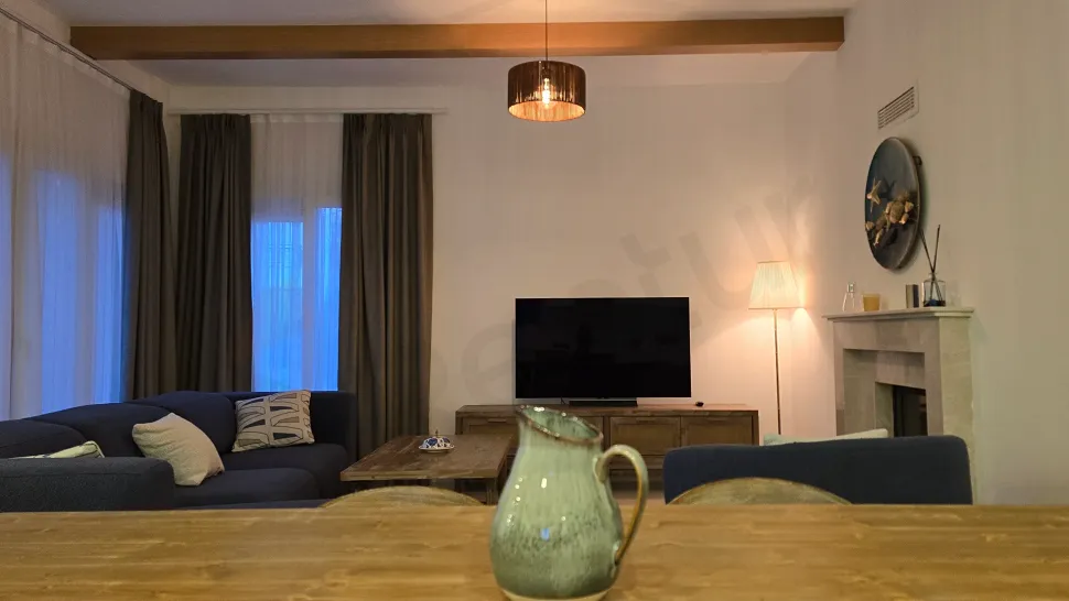 A spacious and bright furnished living room of a villa with modern furniture.