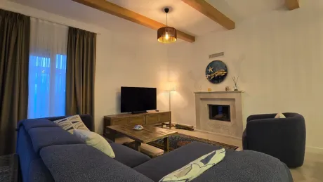 Living room image of a spacious and bright villa furnished with modern furniture.