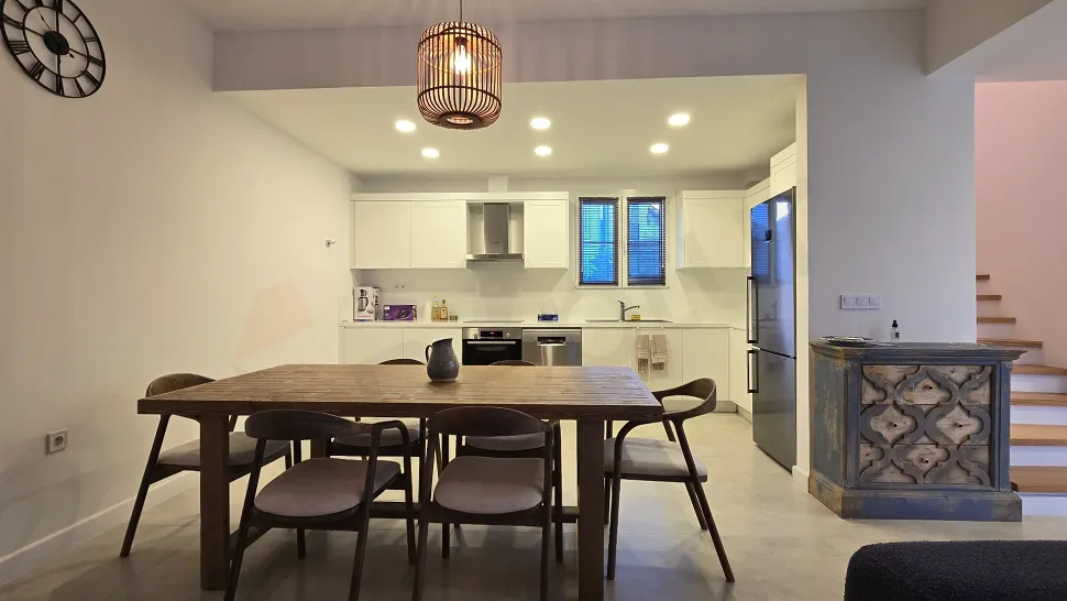 Fully equipped kitchen area with modern design, spacious countertops, and stylish cabinets.
