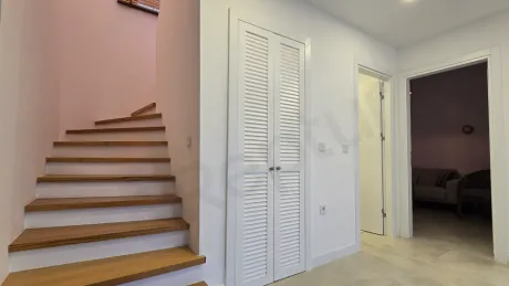 Interior corridor view of a modern and bright villa.
