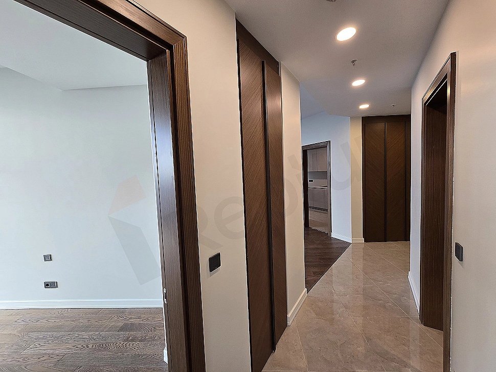 Interior of a modern apartment corridor with wooden floors and lighting details