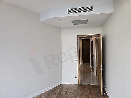 Modern bedroom interior, wide double bed, wooden bedside tables, stylish lampshades and large window