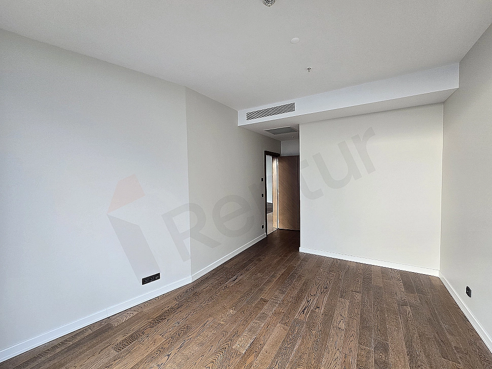 Modern bedroom interior: large bed, stylish nightstands, lamps, painting, and large window