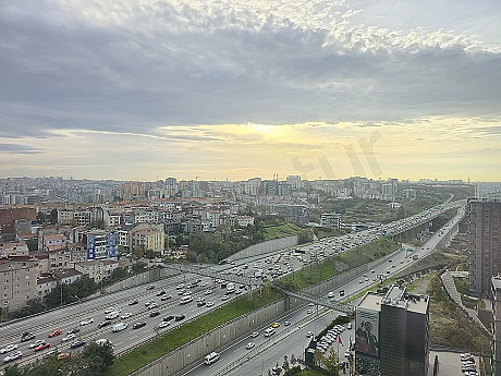 Wide-angle view of a 3+1 apartment for sale in Sarıyer, Istanbul, with forest and city views.