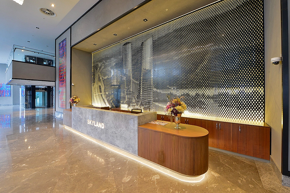Modern building entrance facade with glass and metal details, landscape arrangement