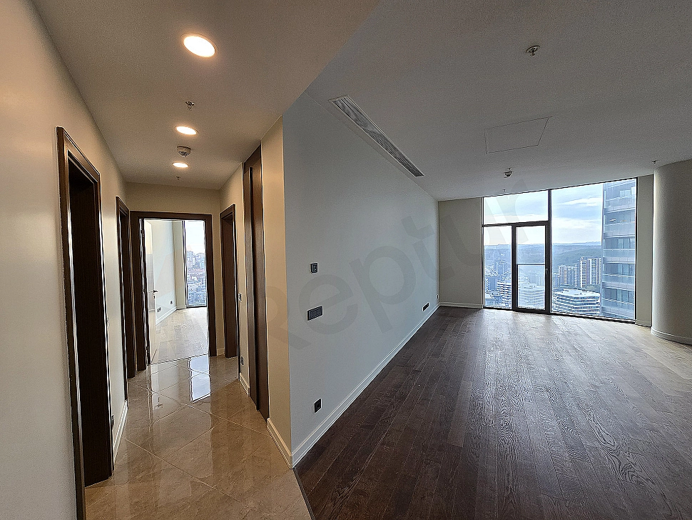 Modern apartment hallway with wooden floor, white walls and spotlight lighting.