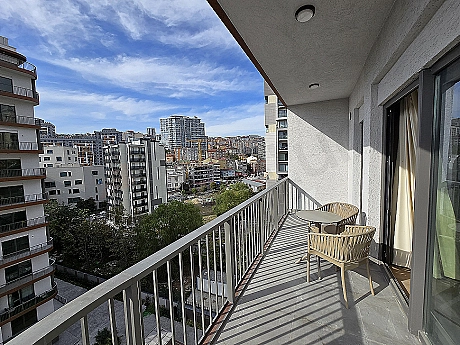 Furnished terrace view. Terrace seating area, plants, and city view.