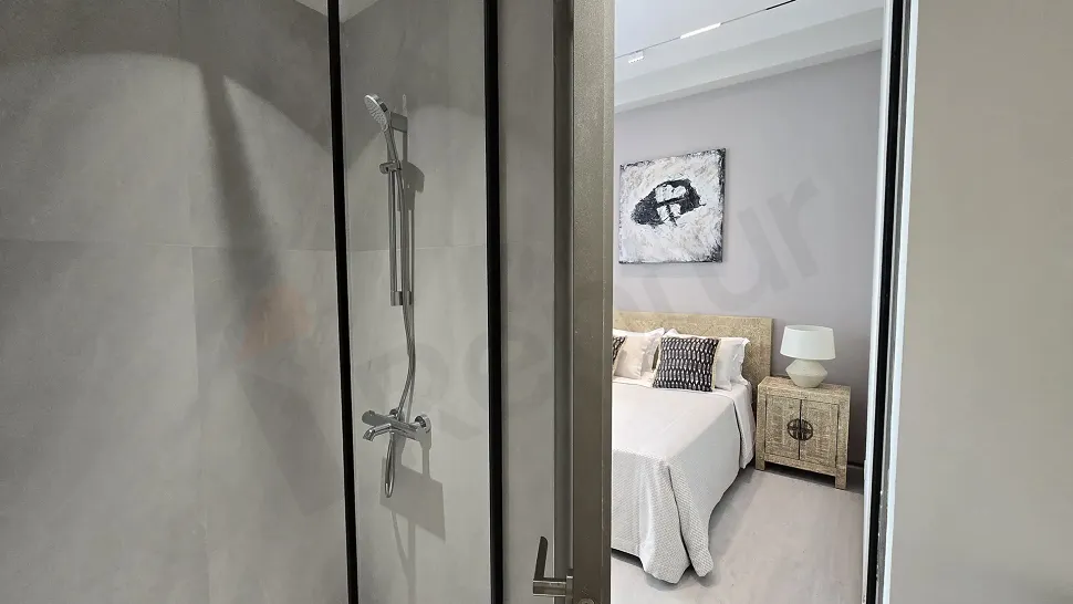 Image of a spacious and airy bedroom with modern architectural design.