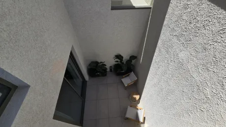 Modern open-top terrace area situated over an inner garden with a spacious design.