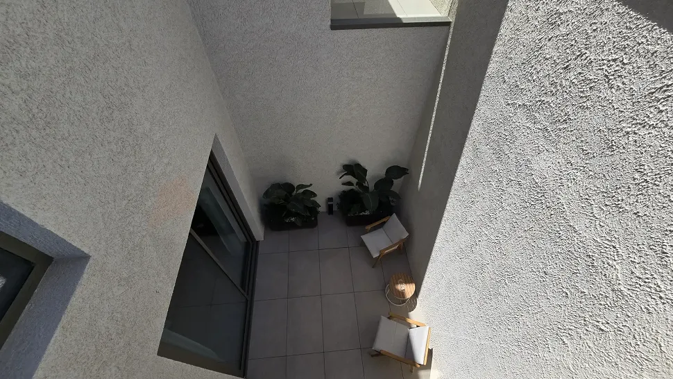 Modern open-top terrace area situated over an inner garden with a spacious design.