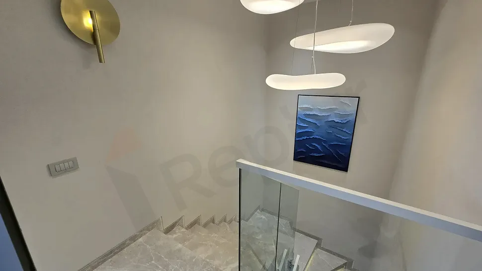 Modern architectural design of an indoor staircase inside a luxury villa.
