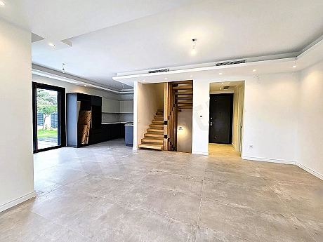 Spacious and airy living room area with large windows and modern architecture.