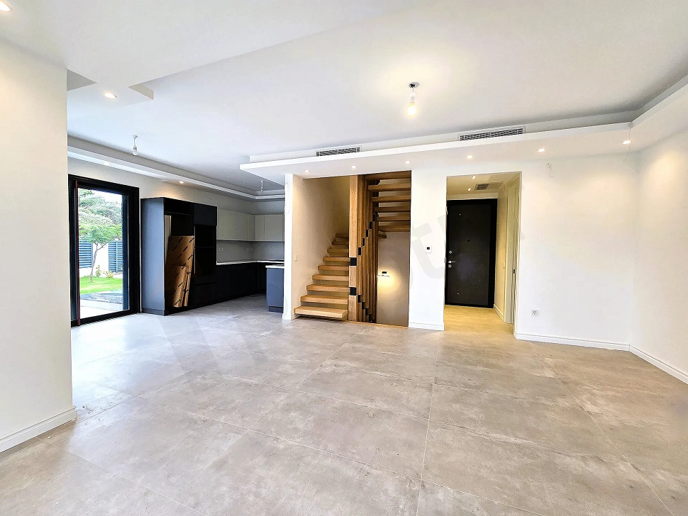 Spacious and airy living room area with large windows and modern architecture.