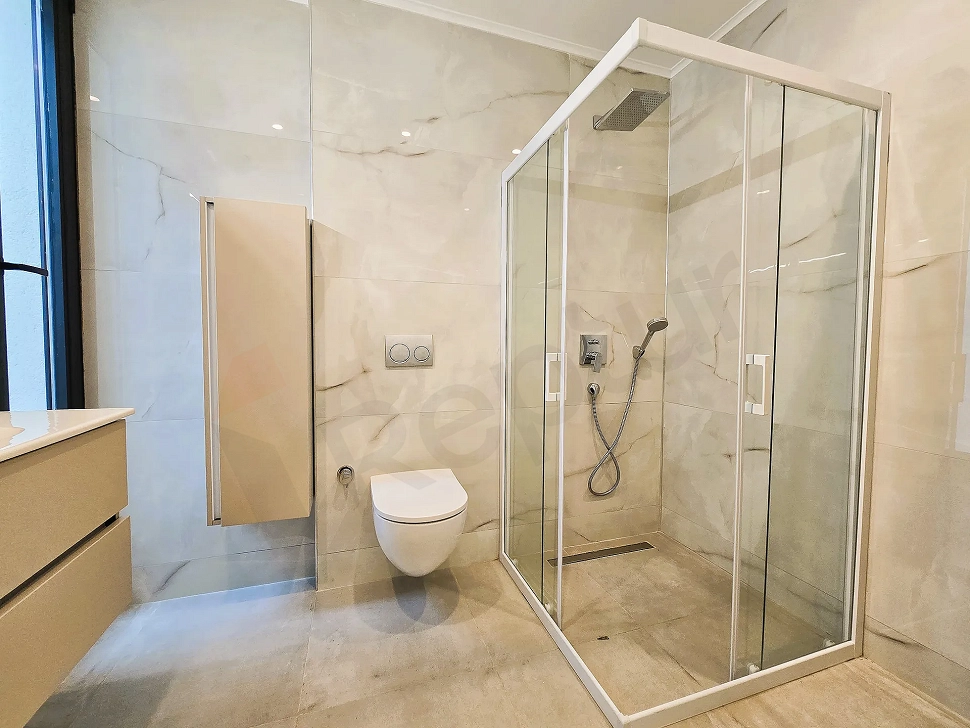 Interior view of a modern and spacious hotel bathroom.