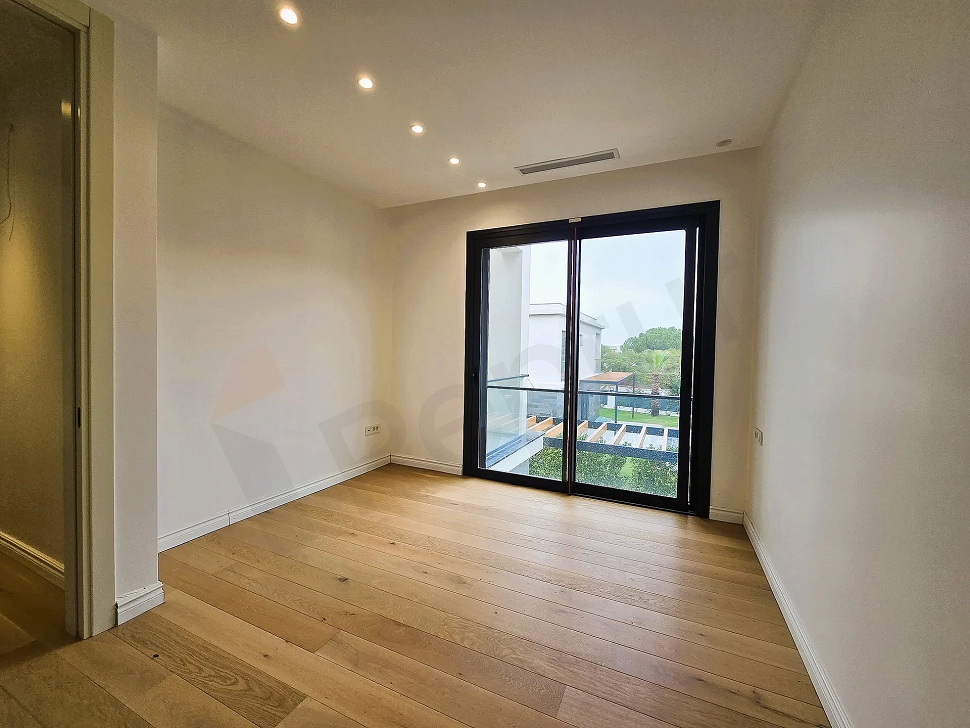 Spacious and bright empty hotel bedroom area with large windows in a project located in Bodrum.