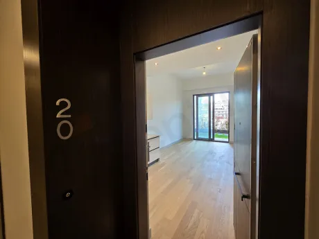 View of the entrance door and hallway of a modern residence apartment.