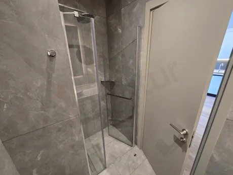 Image of a spacious and stylish bathroom area in a modern residence apartment.