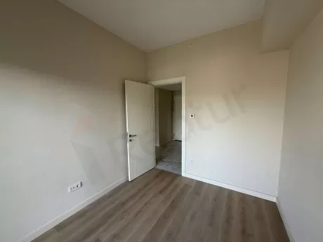 Image of a spacious, bright, and modern empty bedroom with natural light.