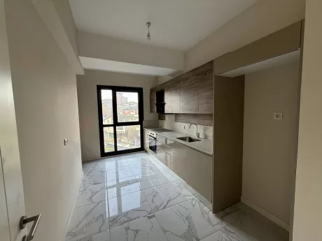 Modern kitchen area with spacious cabinets and countertop space.