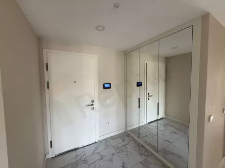 Entrance door and spacious hallway area of a modern apartment.