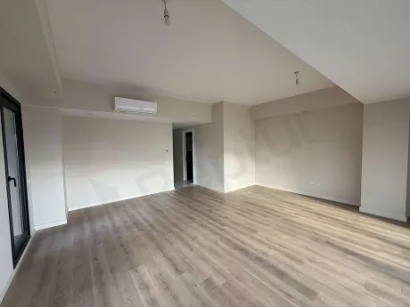 Spacious, bright, and airy dining room area of a modern apartment.