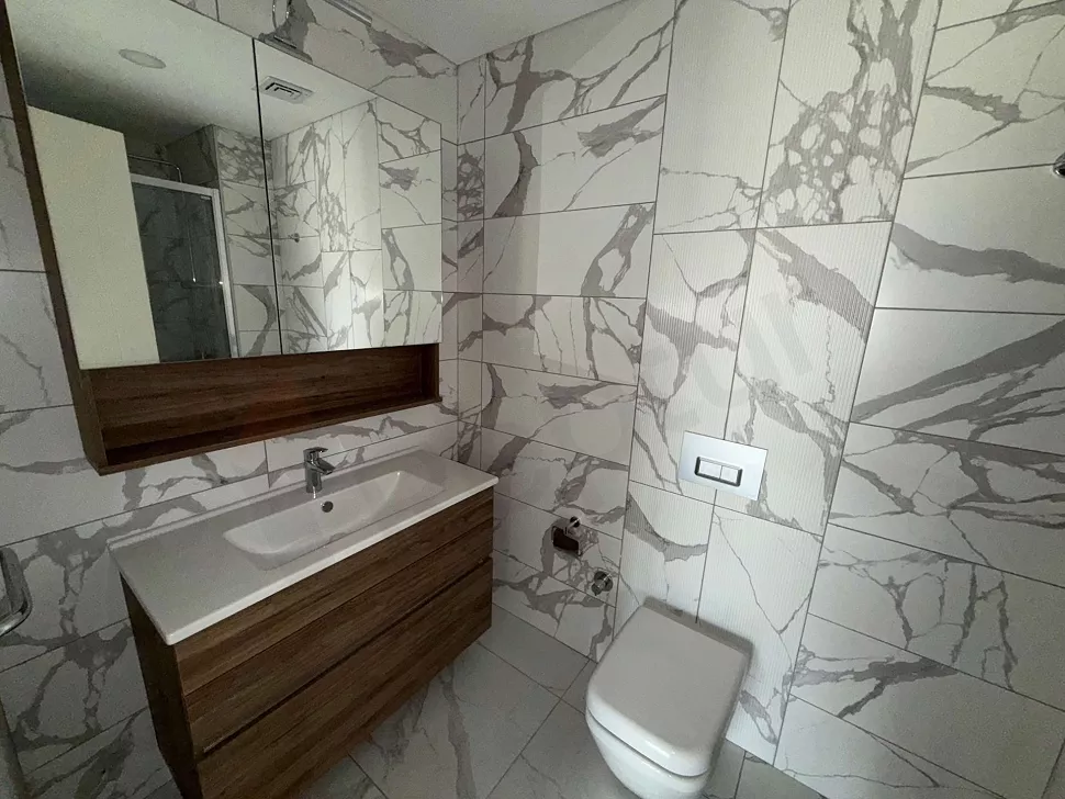 Modern bathroom design with stylish tiles and a spacious interior.