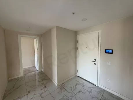 Entrance door and hallway of a modern apartment unit.